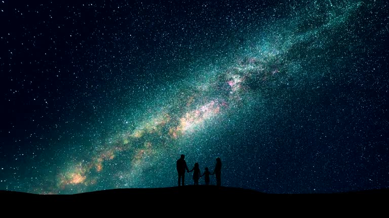 The family standing on the starry sky background. time lapse